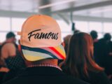 man wearing multicolored Famous cap