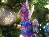 a colorful llama ornament hanging from a christmas tree