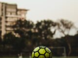 yellow and black soccer ball on field during daytime