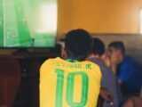 man wears yellow and green jersey shirt