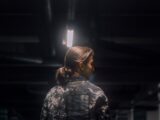 woman in black and white floral shirt standing