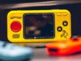 a yellow gameboy sitting on top of a table