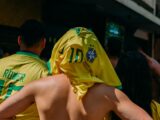 a group of people in yellow shirts standing next to each other