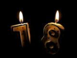 two candles are lit in the shape of numbers