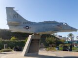 A fighter jet sitting on top of a cement slab