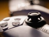 Detailed close-up of a video game controller with focus on buttons and joystick.