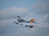 A dramatic airshow performance featuring a military jet with smoketrails in Fairford, UK.