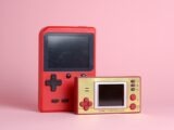 a red nintendo game boy next to a red box