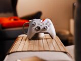 a video game controller sitting on top of a wooden table