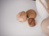 Close-up of minimalistic wooden decorations on a white surface, exuding simplicity and elegance.