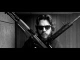a man holding a bunch of guns in his hands
