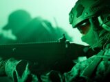 Soldier aiming rifle in green night vision