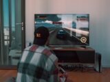 black flat screen tv turned on near white wall