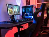 a desk with a computer and a gaming chair