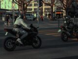 two people riding motorcycles on a city street