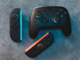 Different nintendo switch controllers on a surface.