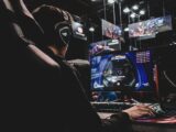 person sitting on gaming chair while playing video game