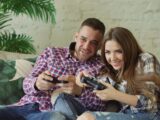 Couple playing video games on couch