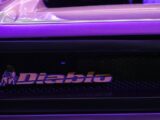 a close up of a purple car with a logo on it