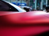 a red sports car parked on the side of the road