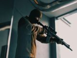 a man holding a gun in his right hand