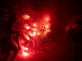 a group of people standing around a firework display