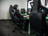 woman in black jacket sitting on black office rolling chair