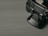 Black PS4 controller on display stand with copy space
