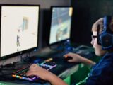 boy wearing headset playing computer game