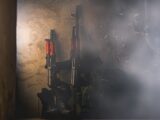 black and red rifle on black surface