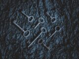 a group of metal keys sitting on top of a table