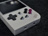 Close-up of a white handheld gaming device.