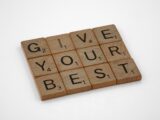 the words give your best written on wooden blocks