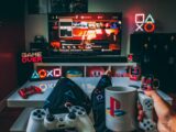a person holding a cup and a game controller in front of a television