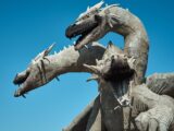 gray dragon statue under blue sky during daytime