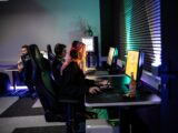 A couple of people sitting at a computer desk