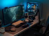 a computer desk with a monitor and keyboard