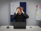 A man sitting in front of a laptop computer