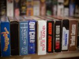 a row of books sitting on top of a shelf