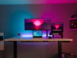black flat screen computer monitor on brown wooden desk