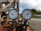 a couple of gauges sitting on top of a rusted train