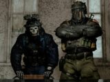 Two soldiers in tactical gear standing indoors