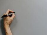 person holding black and white pen
