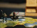 a couple of figurines sitting on top of a table